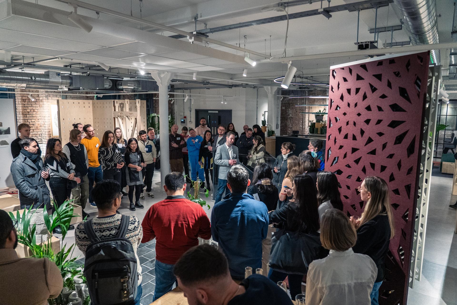 Audience at a 3D printing event, engaging in discussion about sustainable design and Full Circle Concrete's innovative projects.
