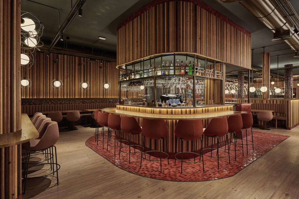 Modern bar interior design featuring wooden paneling and stylish seating, part of Masquespacio's project for Piur restaurant.
