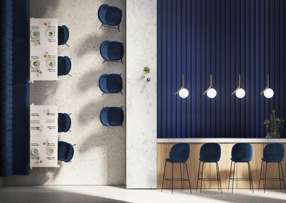Stylish interior of a modern dining space with navy chairs and a sleek countertop, showcasing contemporary design elements.