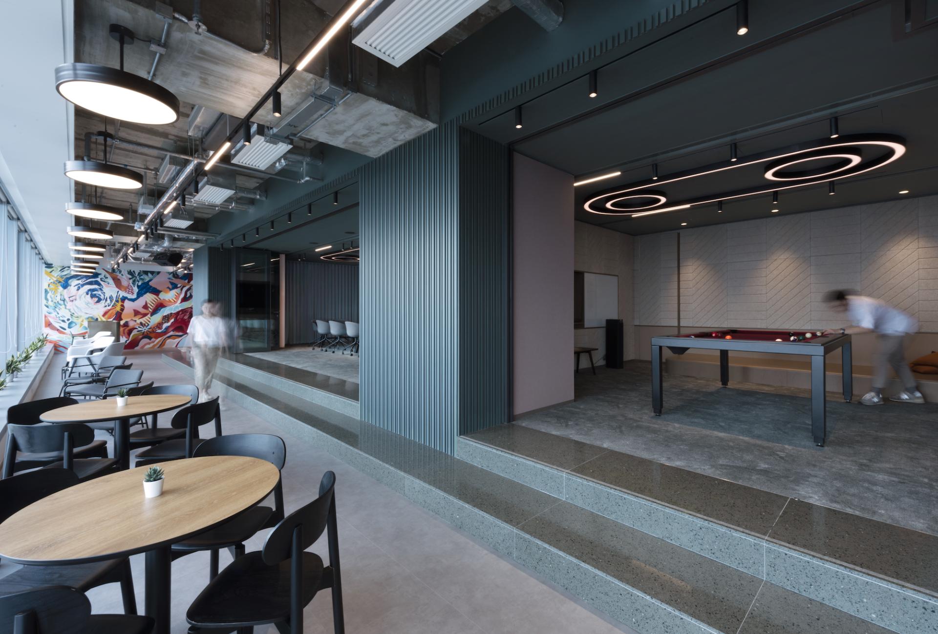 Modern office interior design by Bean Buro for Warner Music Hong Kong, featuring collaborative spaces and vibrant decor.