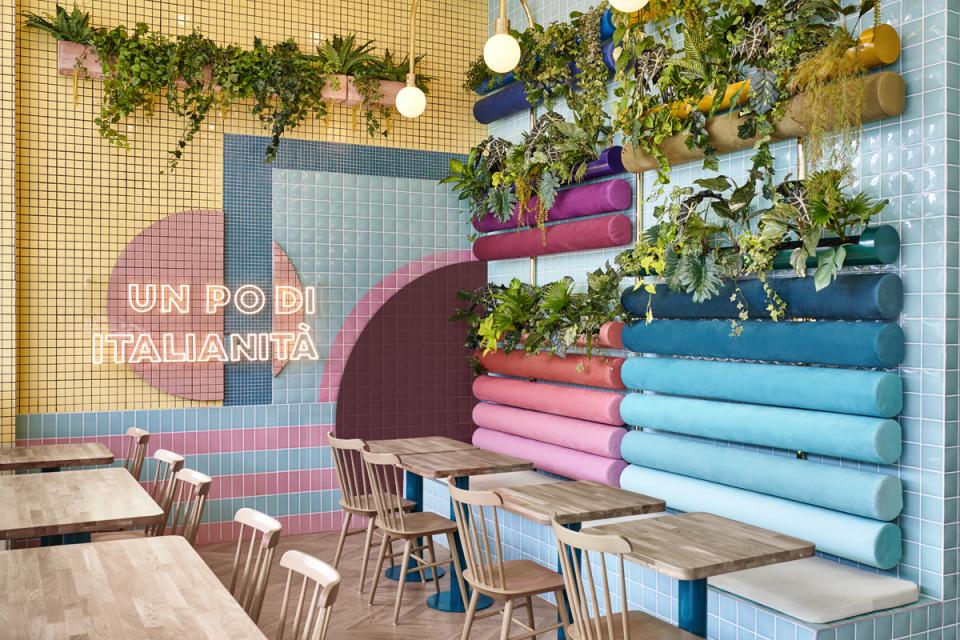 Colorful interior design featuring plants and playful wall elements at Piada, an Italian restaurant in Lyon.