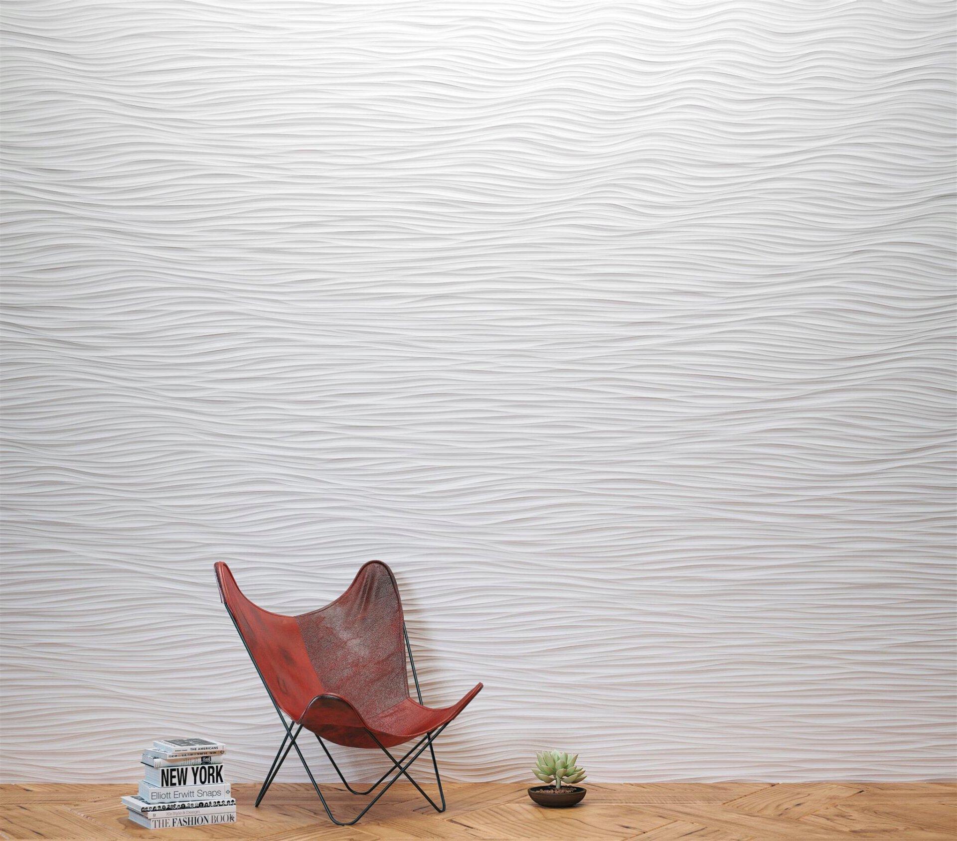 Textured white wall featuring CDUK's M|R Walls, accompanied by a stylish red chair and decorative elements.