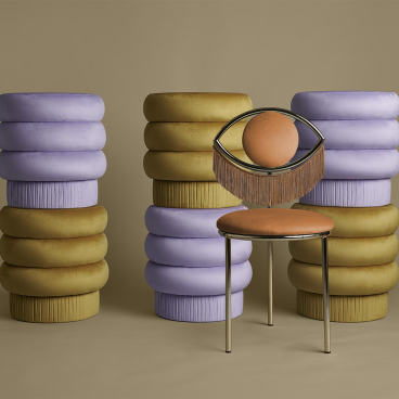 Wink chair by Masquespacio surrounded by colorful, stacked seating elements, showcasing modern design and innovative materials.