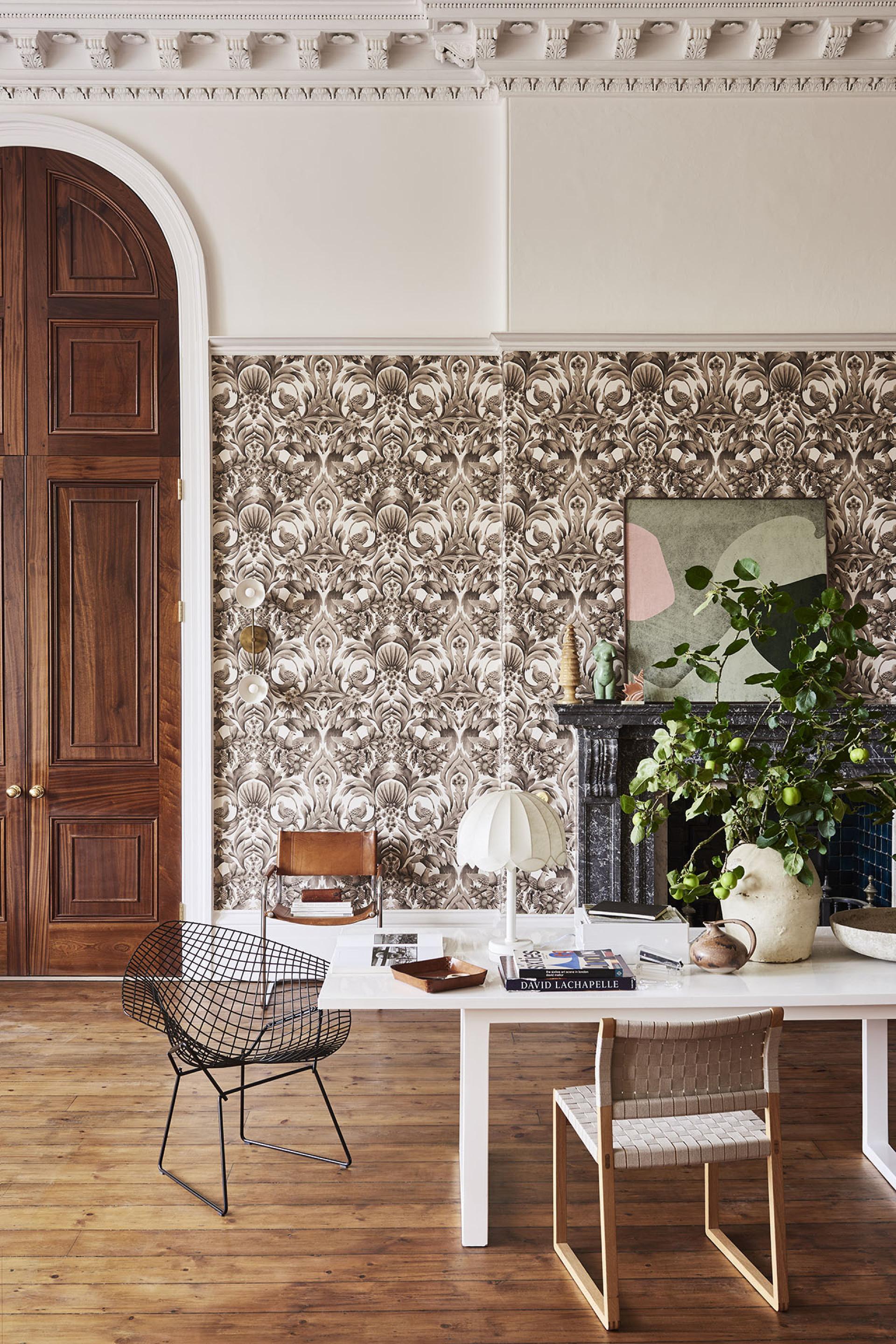 Stylish interior featuring Cole & Son wallpaper, modern furniture, and a blend of natural and artistic decor elements.