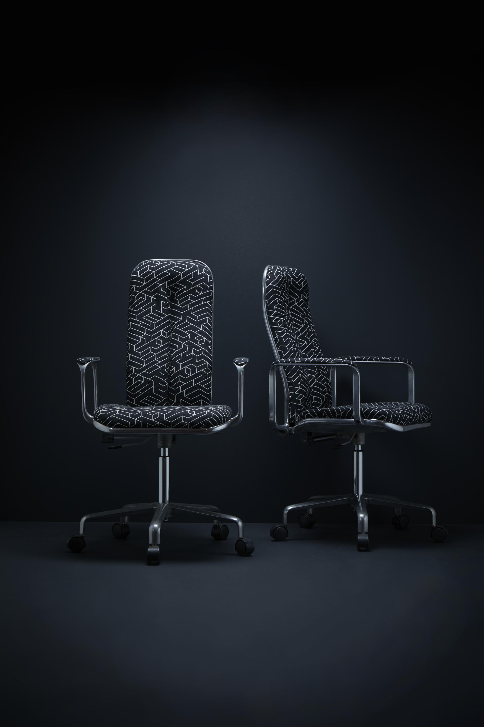 Stylish office chairs with geometric patterns, emphasizing comfort and design, showcased against a dark background.
