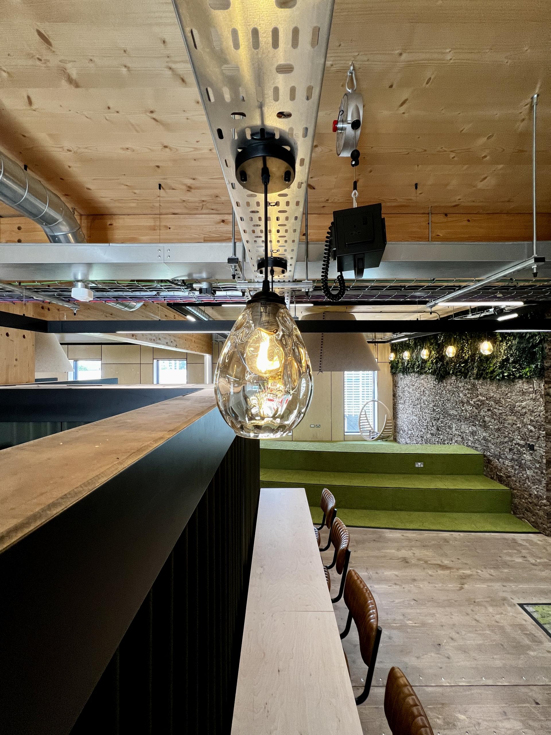 Stylish pendant light illuminating a modern workspace designed for net-zero carbon initiatives in Leeds.
