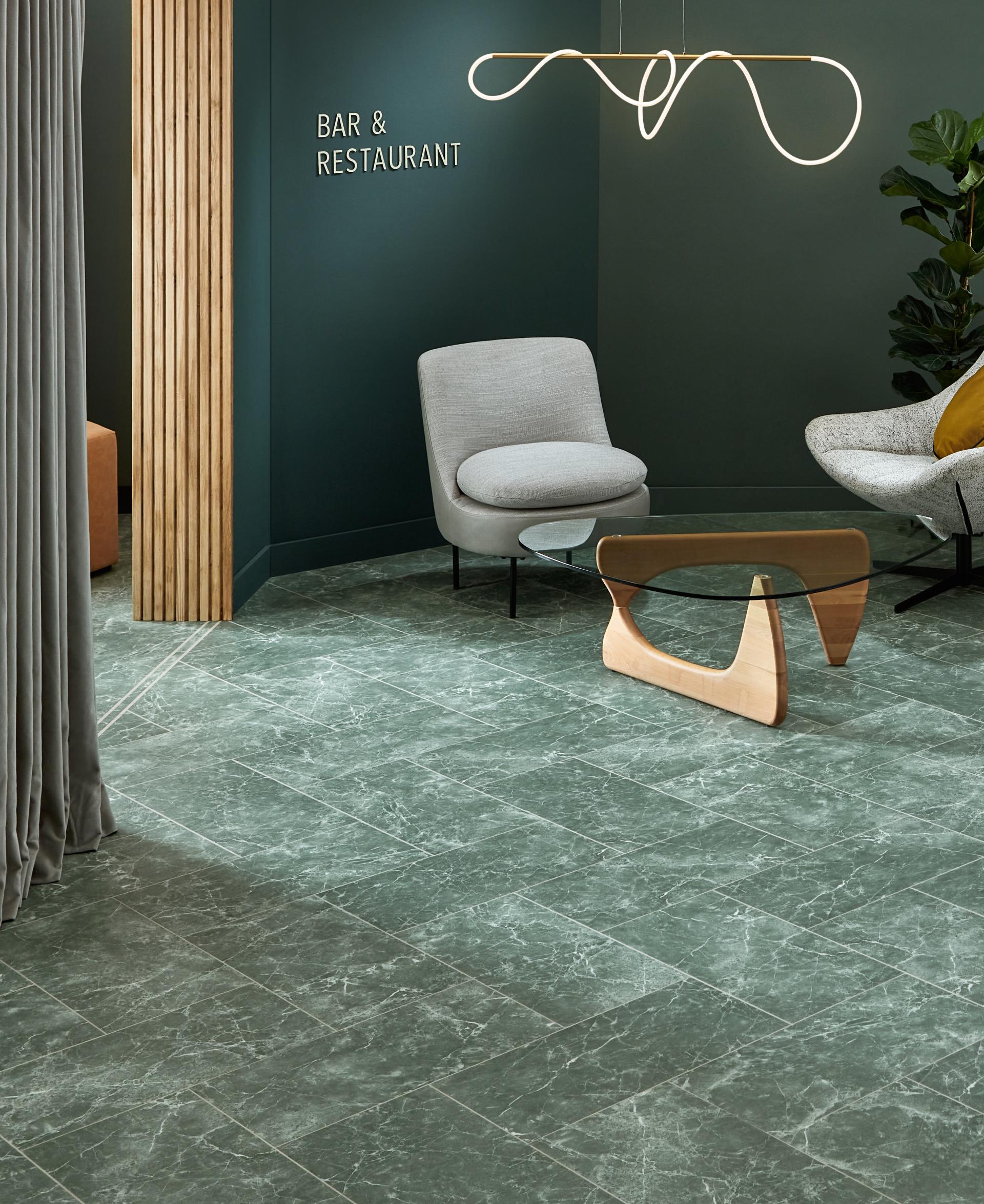 Stylish lounge area featuring Amtico's Signature LVT collection with modern furniture and a calming green color palette.