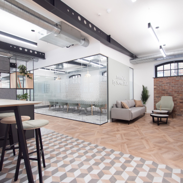 Modern office space interior featuring IVC Commercial's modular vinyl flooring at Assemble by Seven Dials, showcasing a collaborative environment.