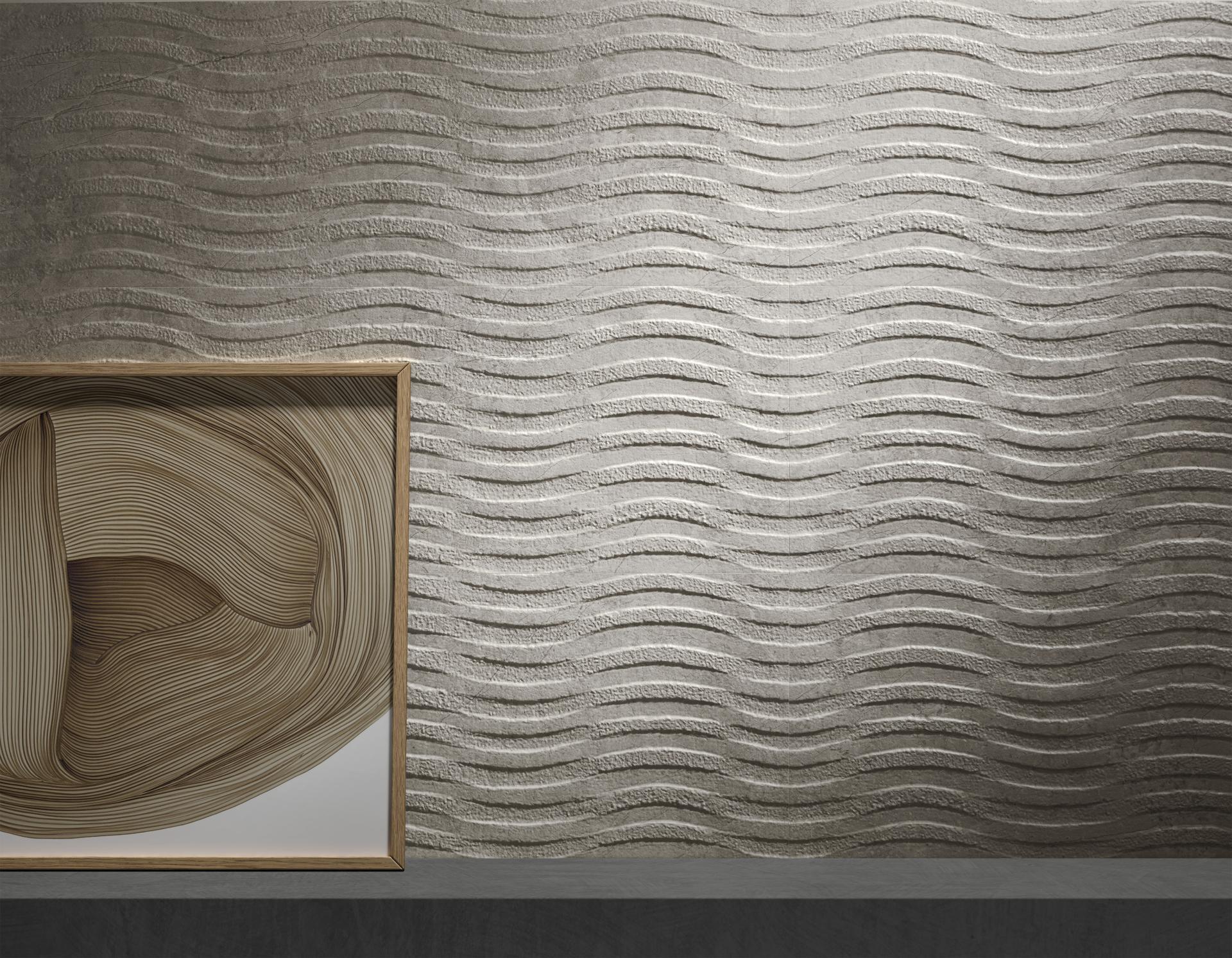 Textured wall design featuring wave patterns, paired with a framed abstract artwork, highlighting modern Spanish tile trends.
