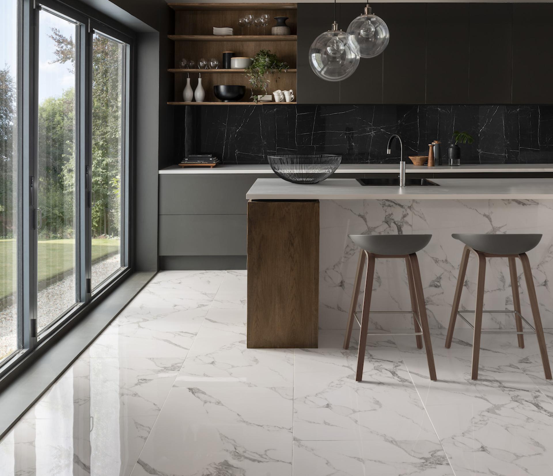 Modern kitchen featuring marble tiles, sleek cabinetry, and large windows with natural light showcasing Parkside tiles for housebuilders.