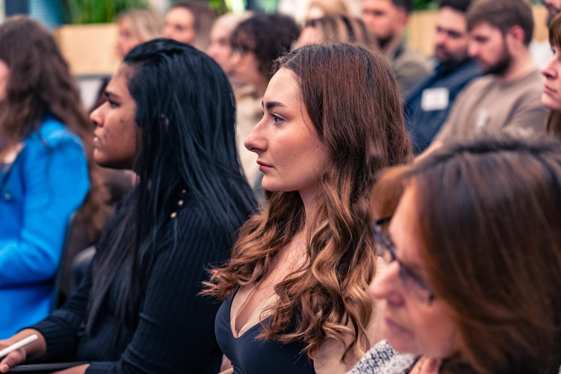 Diverse audience engaged in discussion about achieving Net Zero and the importance of materiality in sustainability.