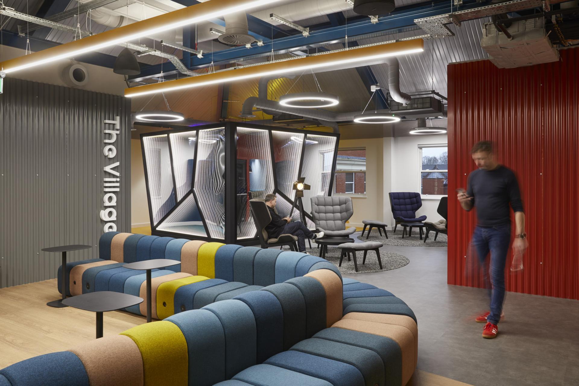 Modern coworking space featuring colorful seating and collaborative areas, emphasizing a creative and sustainable environment in the North West.