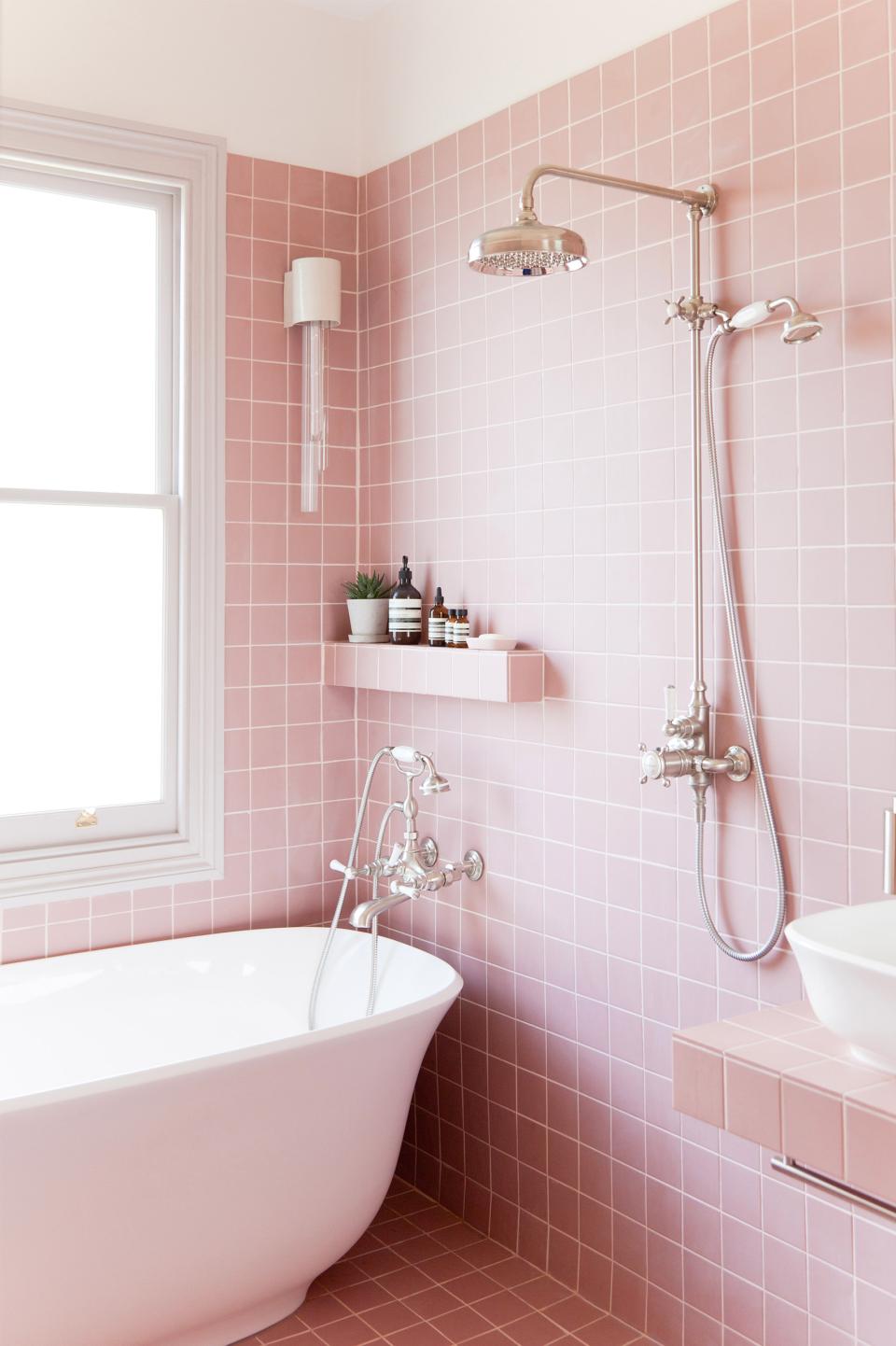 Stylish pink bathroom featuring a freestanding tub, modern fixtures, and elegant decor for a contemporary home design.