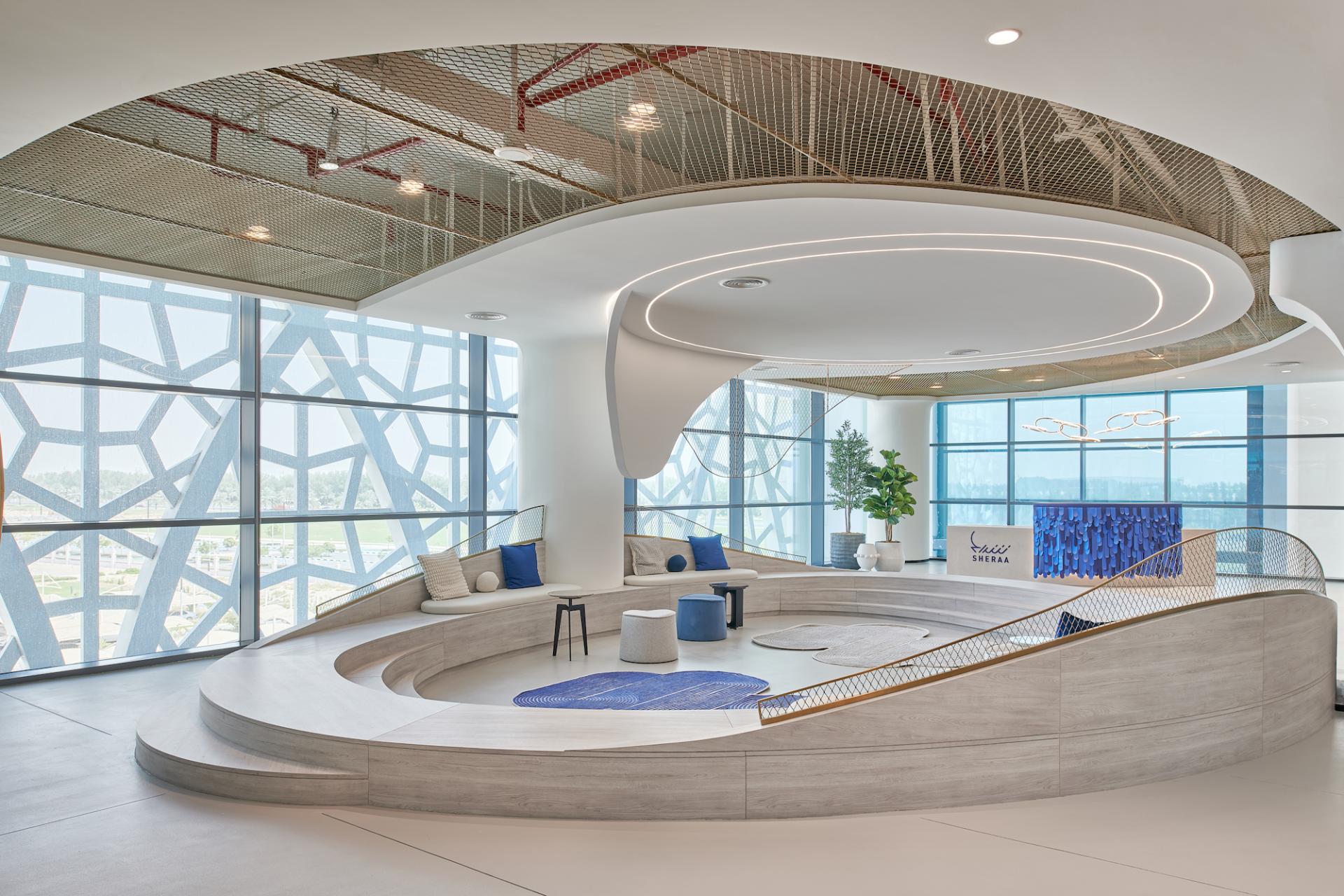 Modern workspace featuring a curved seating area and large windows, designed for the Sharjah Entrepreneurship Center.