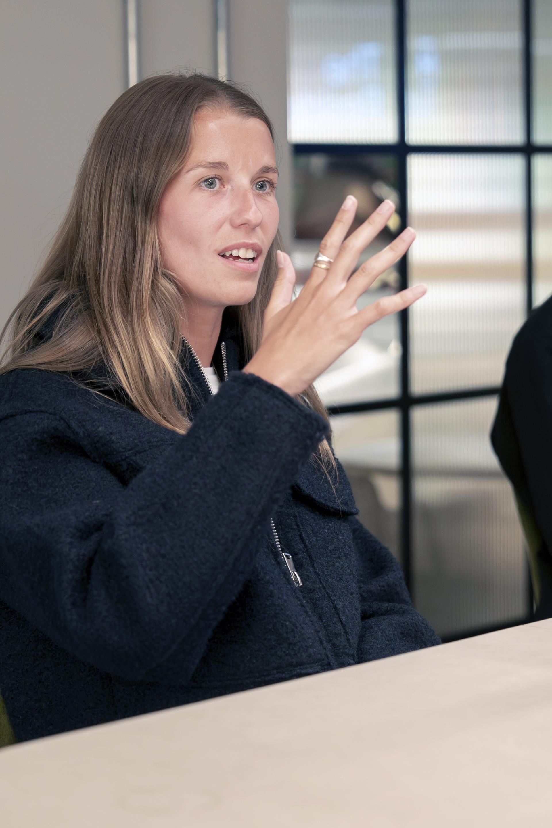 Participant engaging in discussion during a Manchester property seminar, highlighting diverse residential perspectives.