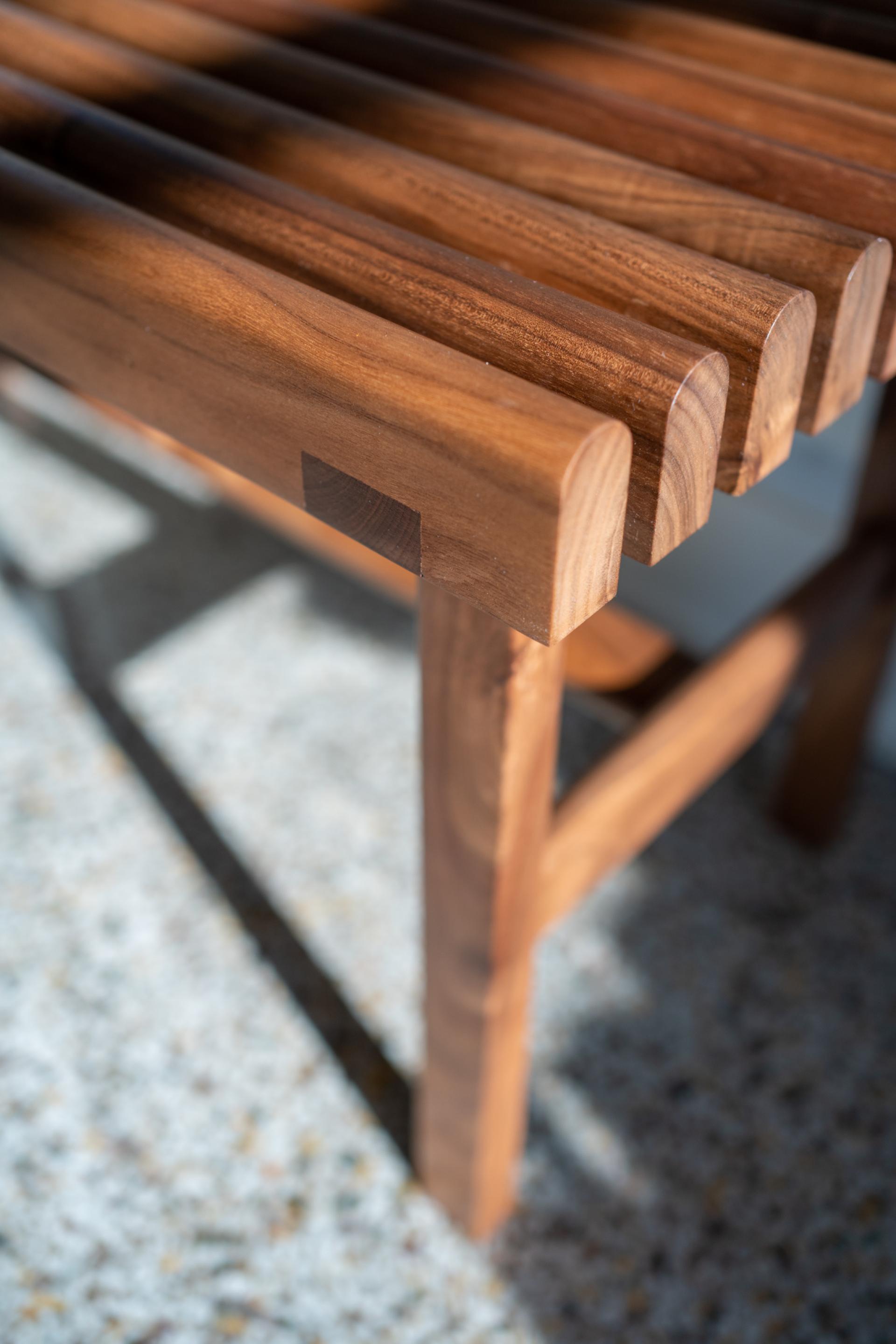 Handcrafted wooden bench with a sleek design, showcasing the artistry of Midwest furniture designer Maggie Jo Sanderson.