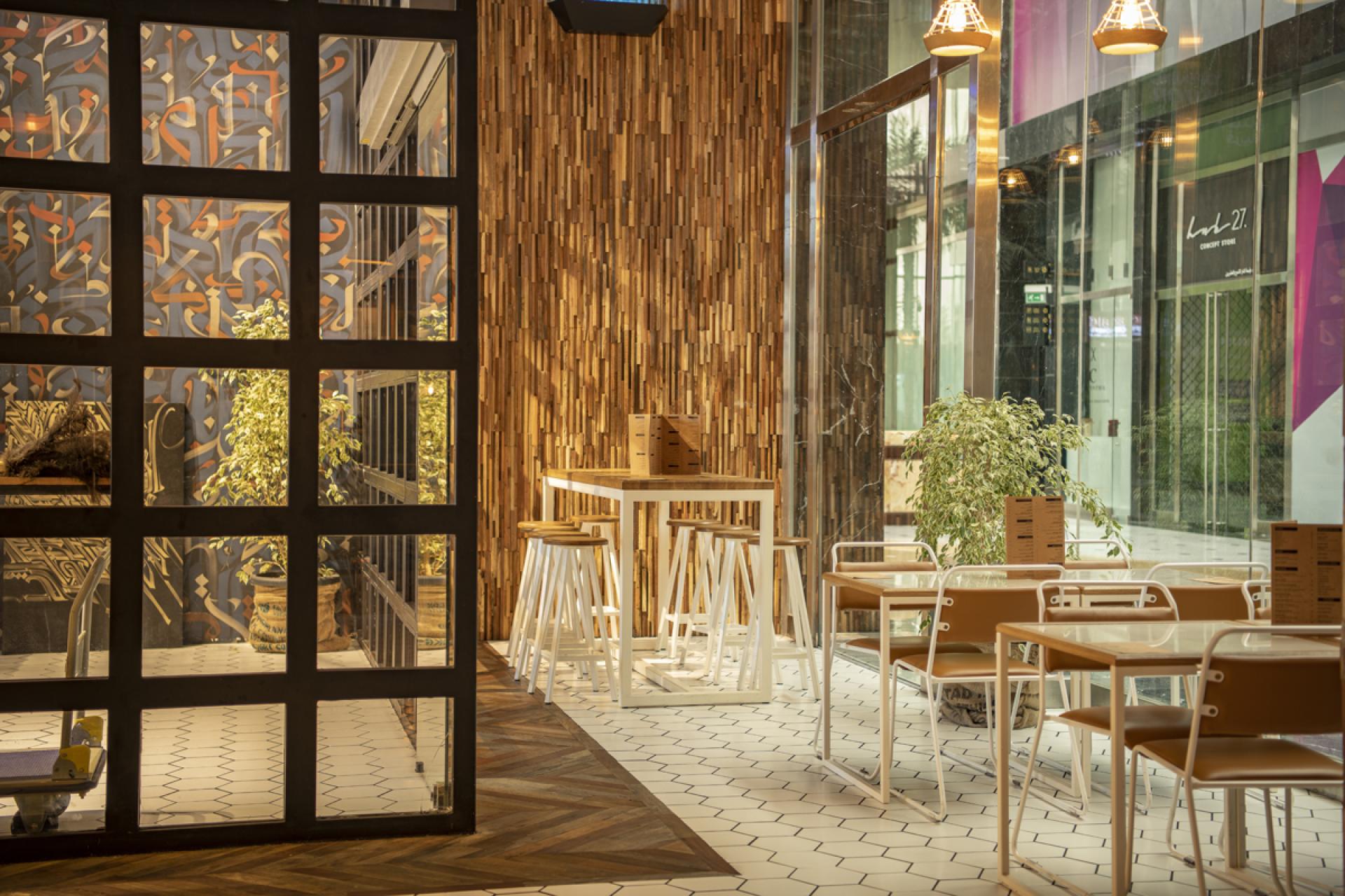 Contemporary interior of Brew92 cafe, featuring wooden accents, stylish seating, and vibrant decor by Liqui Design.