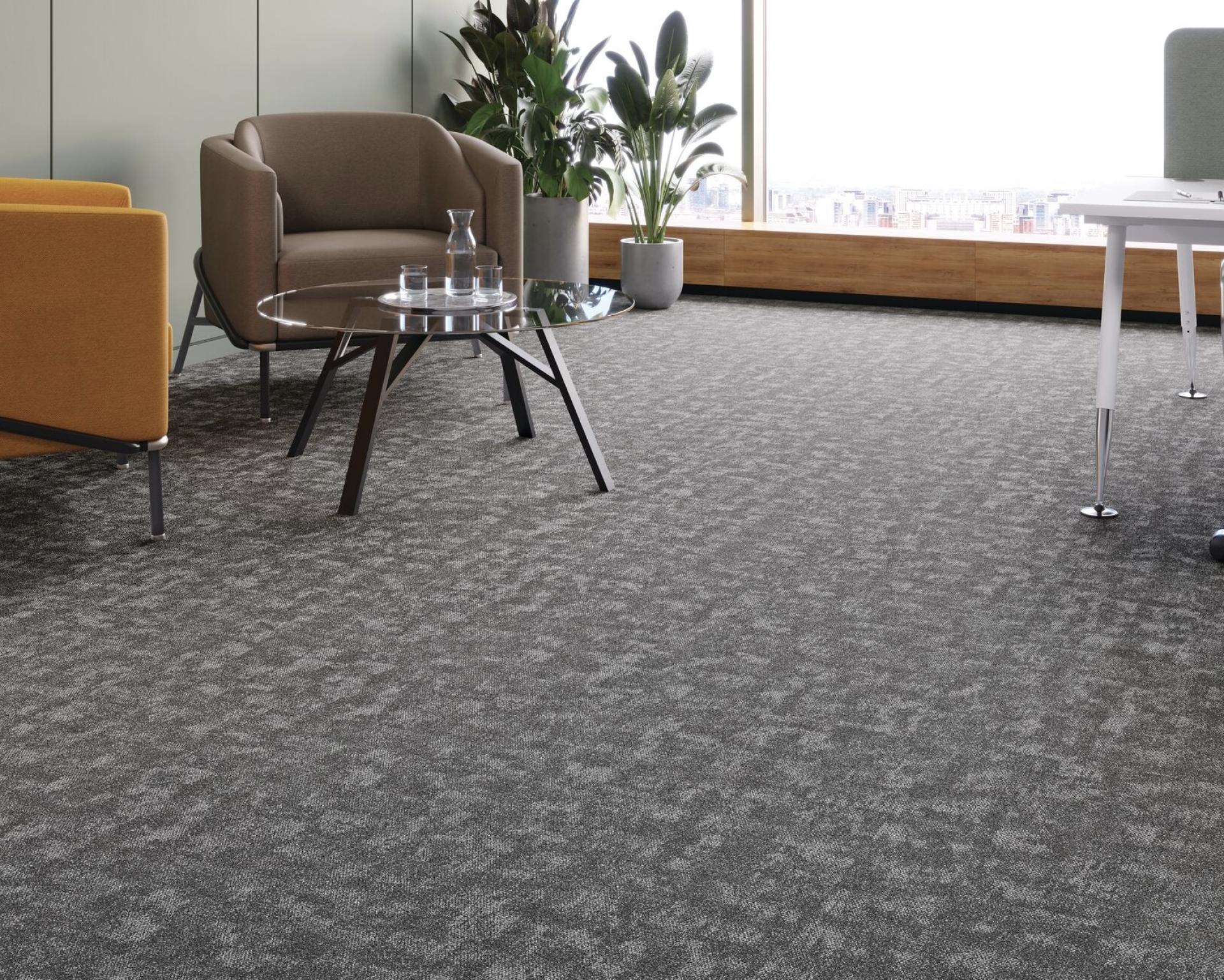 Stylish office space featuring Forbo's Tessera Union flooring, modern furniture, and greenery creating a harmonious environment.