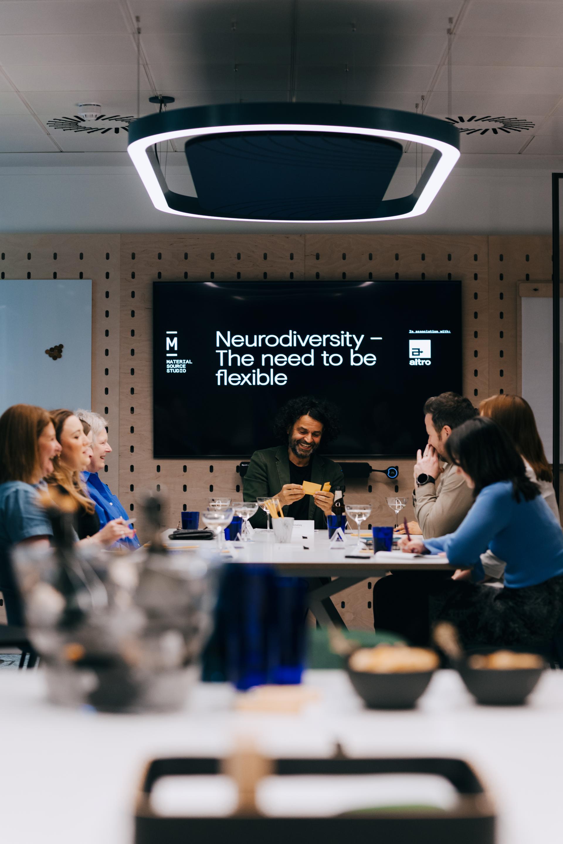Roundtable discussion on neurodiversity at Material Source Studio, featuring participants engaging in collaborative dialogue.