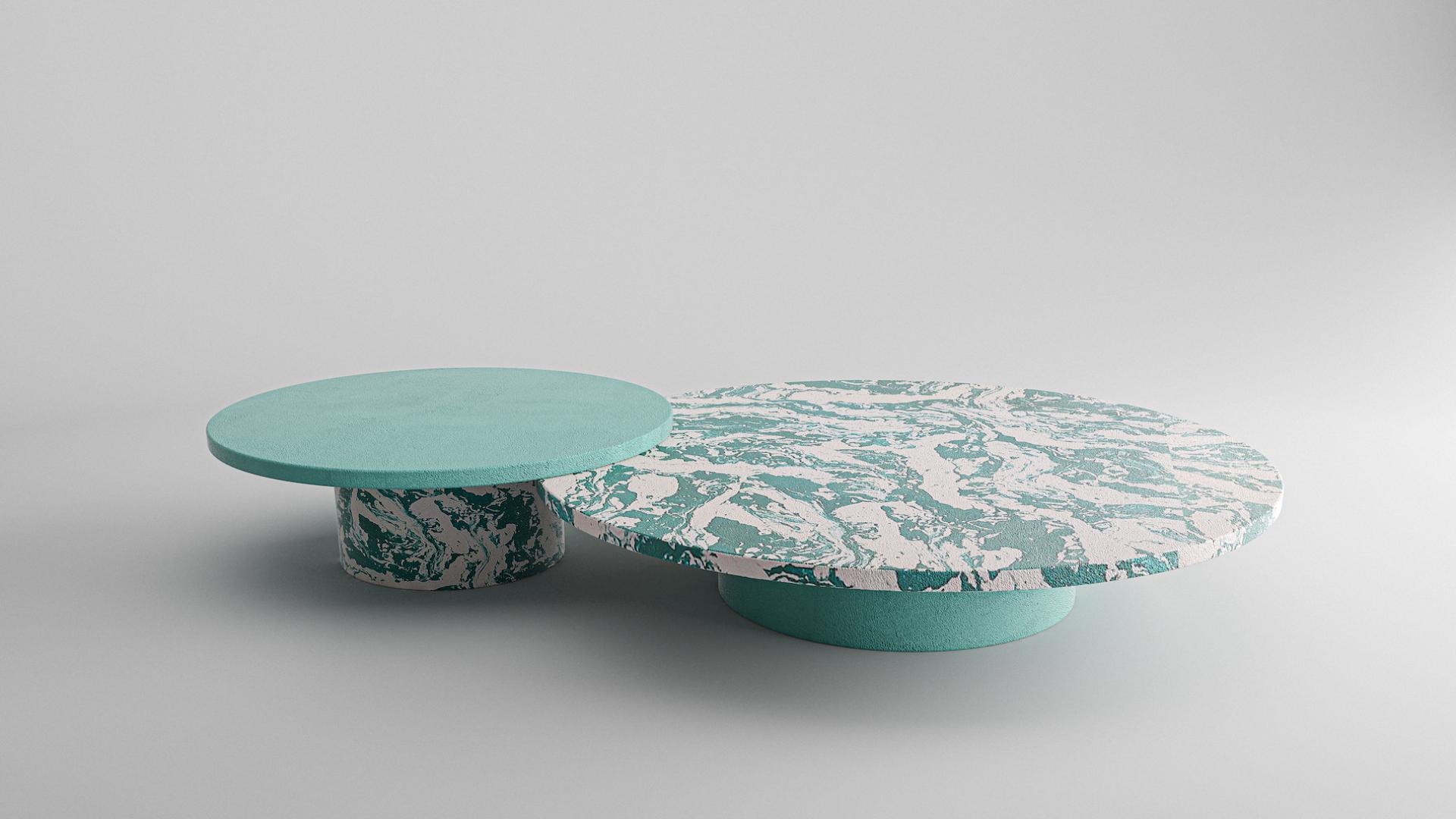 Unique concrete coffee tables featuring artistic turquoise patterns, embodying the beauty of imperfection and contemporary design.