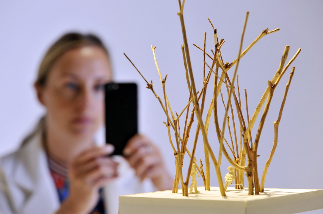 A member of staff at Japan House London, the new home for Japanese culture in London, inspects 'Between a Tree', one of 100 exhibits on display in the inaugural exhibition, Futures of the Future