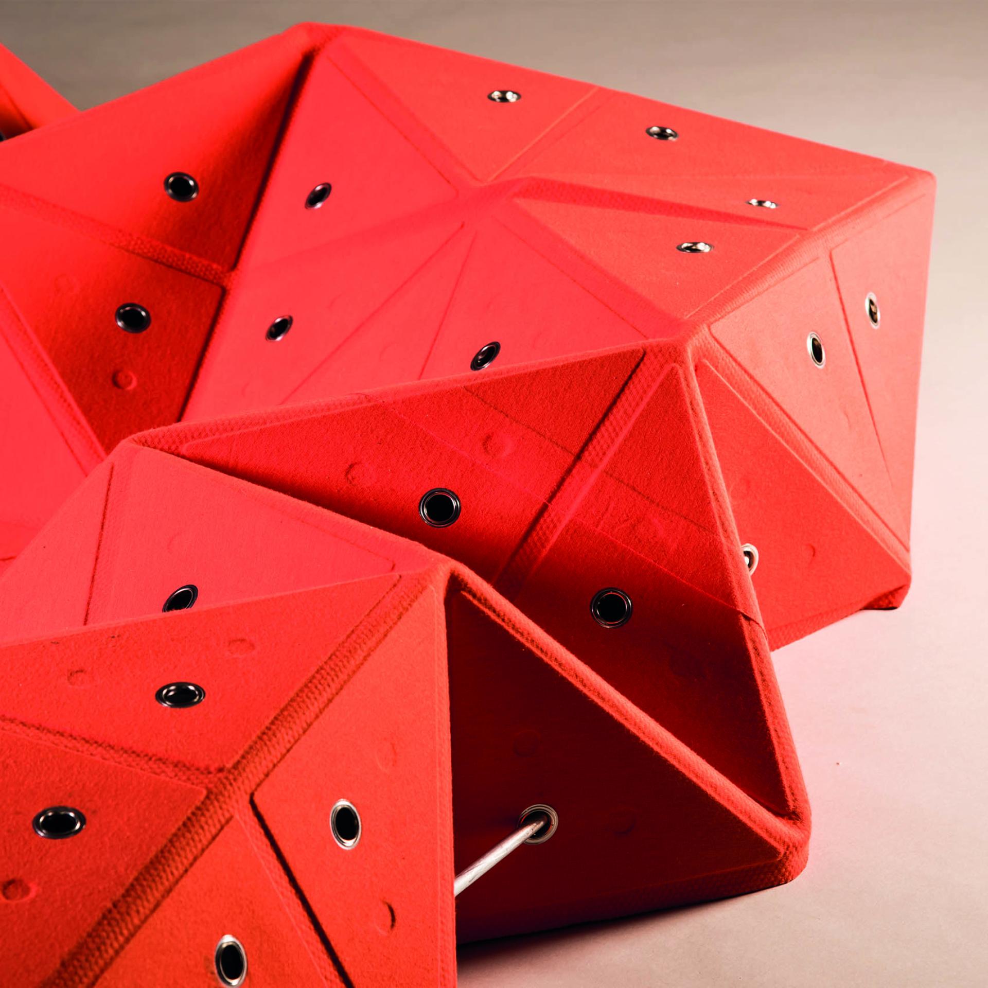 Innovative red geometric seating design showcased at the Surface Design Show 2020 in London.