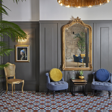 Elegant seating area featuring Karndean Designflooring, historic decor, and a statement mirror in CoVault's Glasgow location.