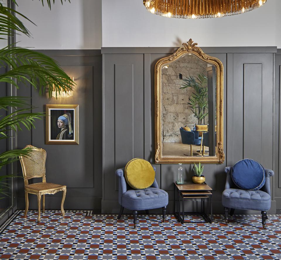 Elegant seating area featuring Karndean Designflooring, historic decor, and a statement mirror in CoVault's Glasgow location.