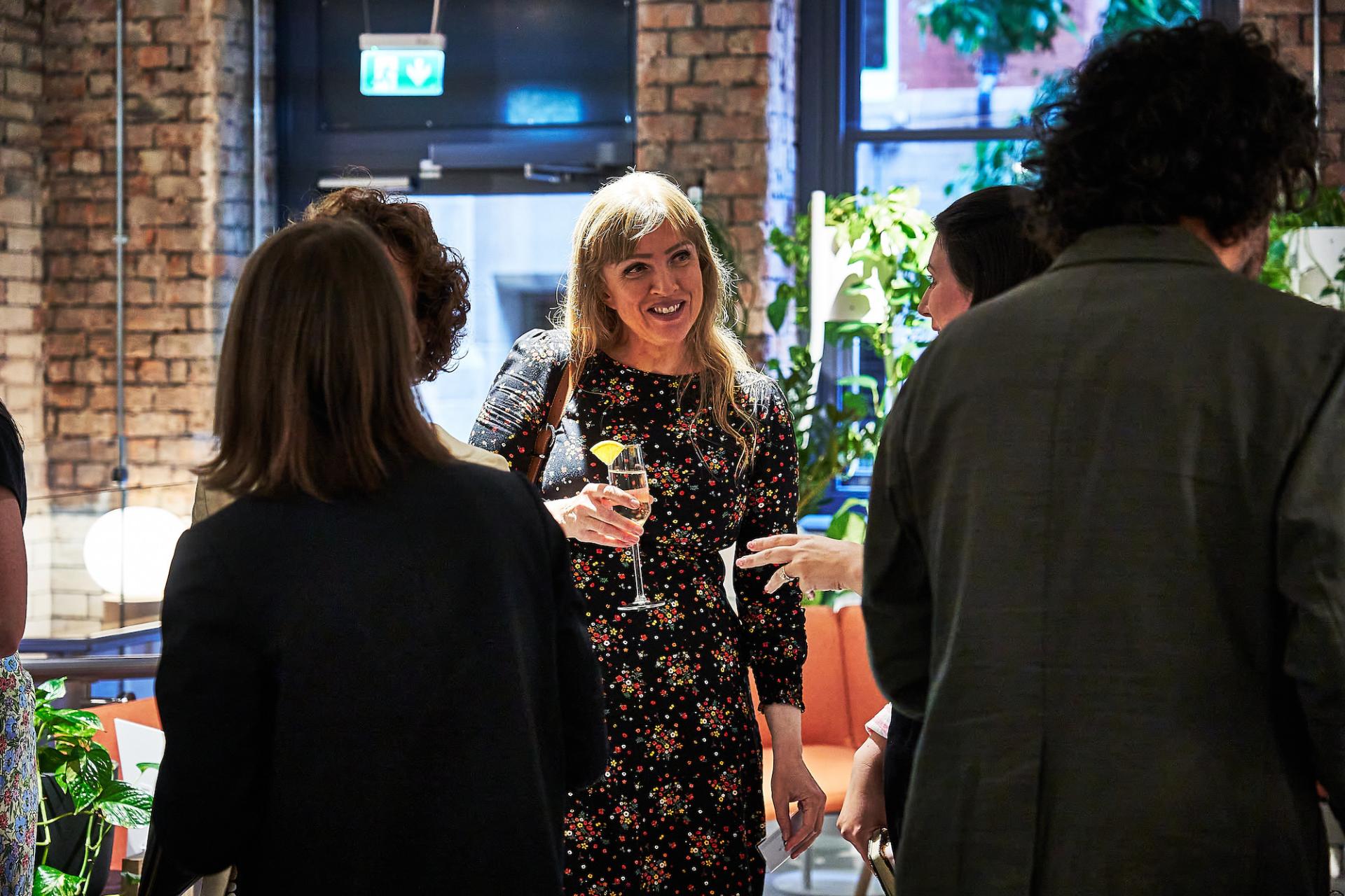 Celebration at the 42 Gathering event, featuring attendees networking and enjoying drinks in a vibrant setting.