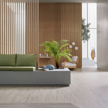 Modern interior design showcasing Forbo's Marmoleum Linear Collection with green accents and natural light elements.