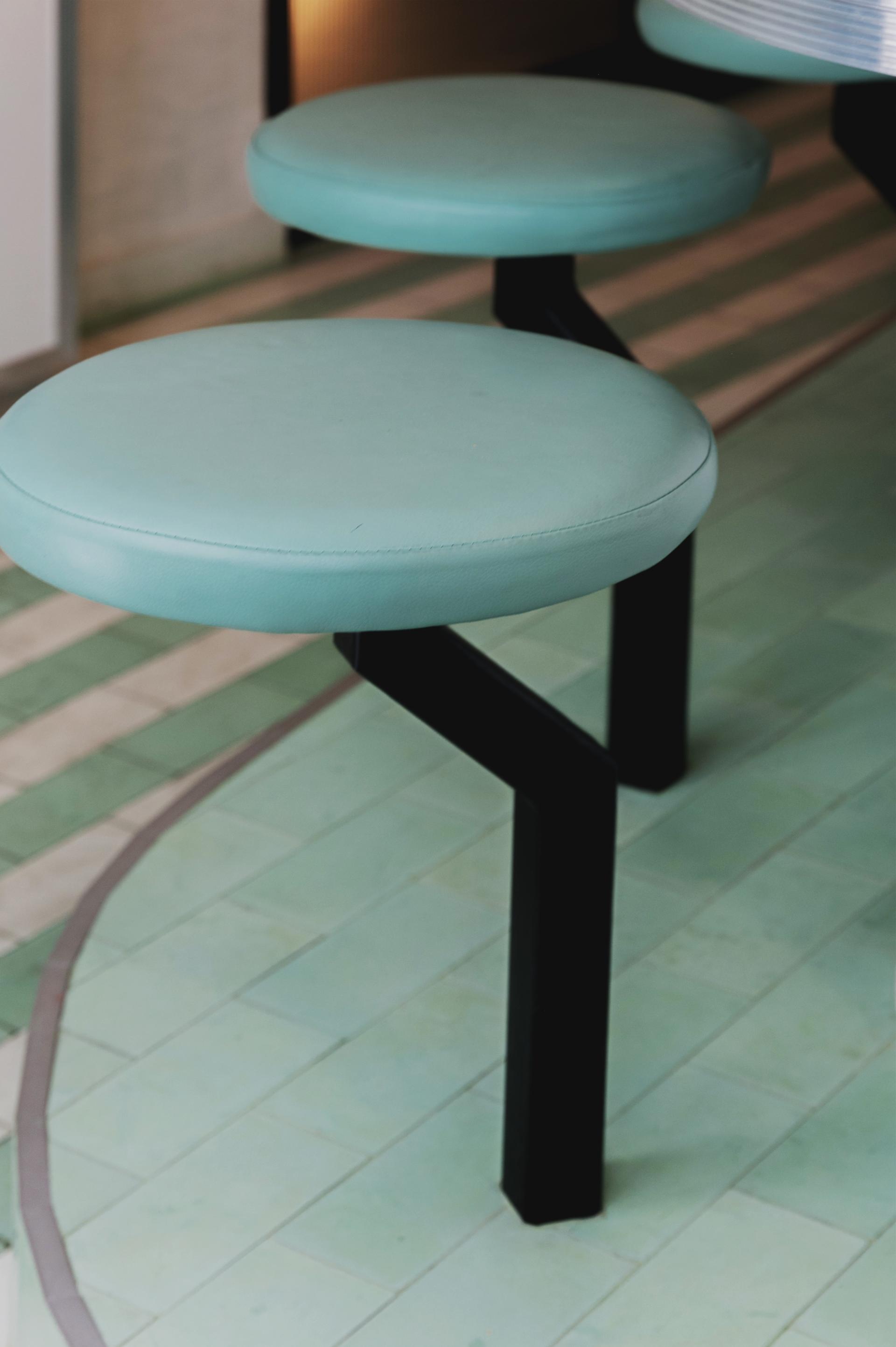 Elegant blue and white striped stools in an Italian restaurant, complementing the Art Deco design in Soho's Lina Stores.