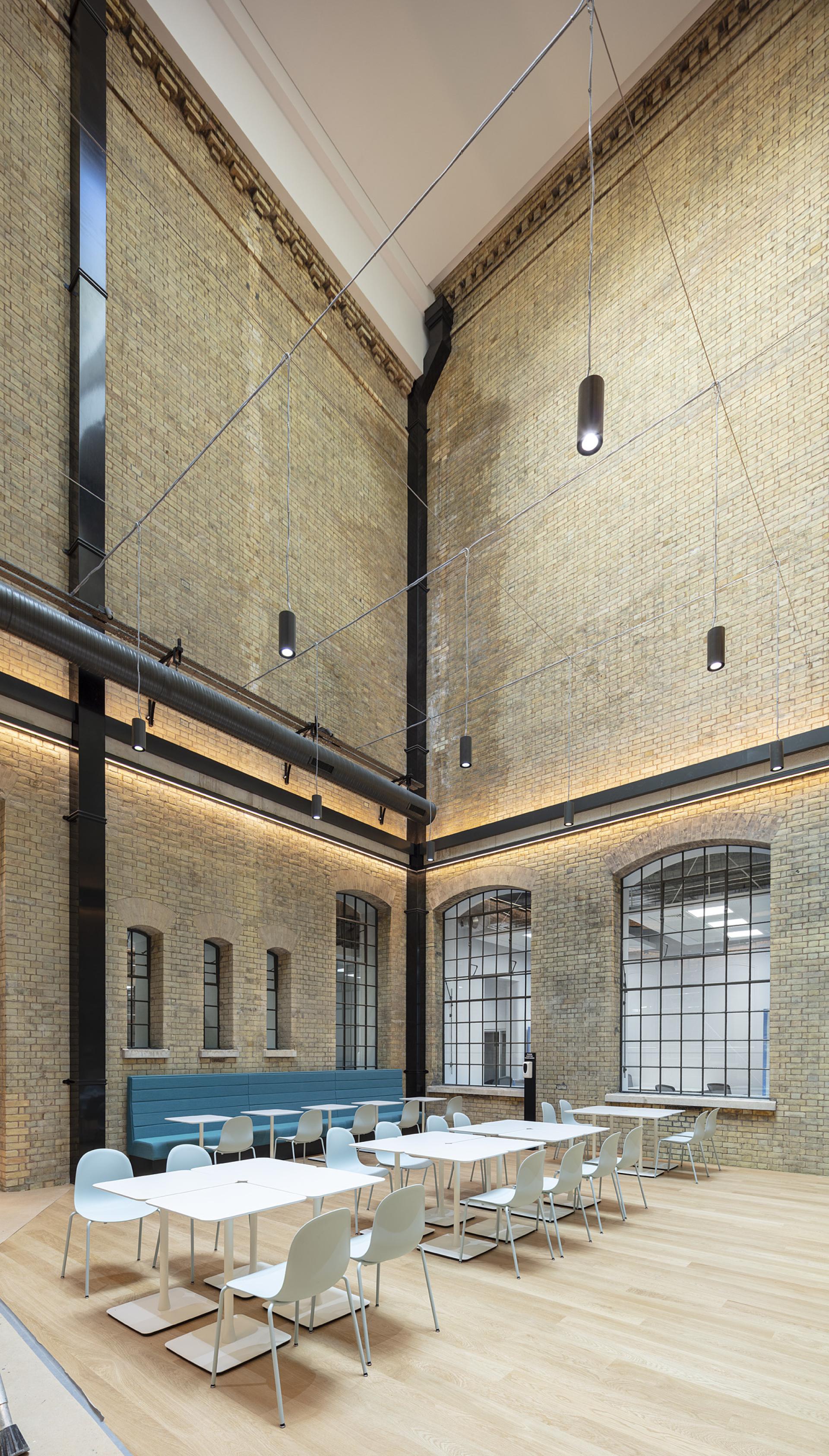 Bright, modern office space in The National Gallery's One Accommodation Hub, featuring large windows and sleek furniture.