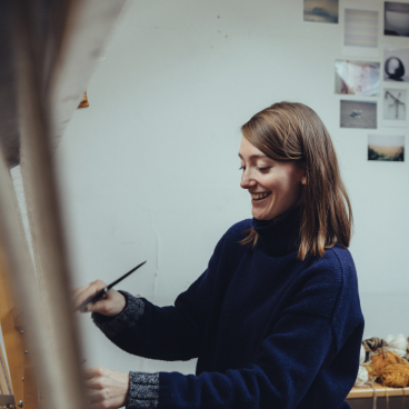 Christabel Balfour, a tapestry weaver in southeast London, joyfully works on her craft in a bright studio.