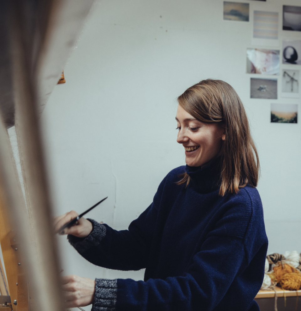 Christabel Balfour, a tapestry weaver in southeast London, joyfully works on her craft in a bright studio.
