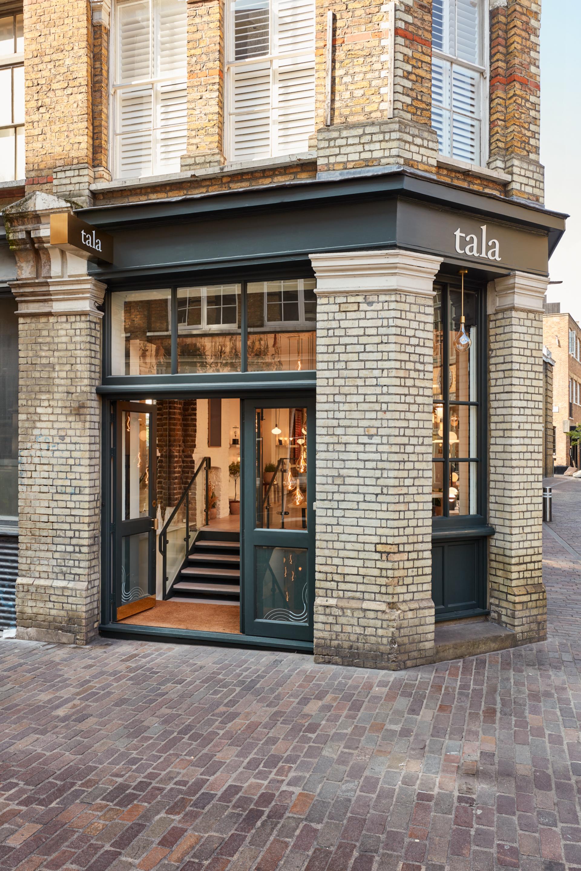 Tala showroom in Shoreditch featuring a stylish entrance with green accents and contemporary lighting design.