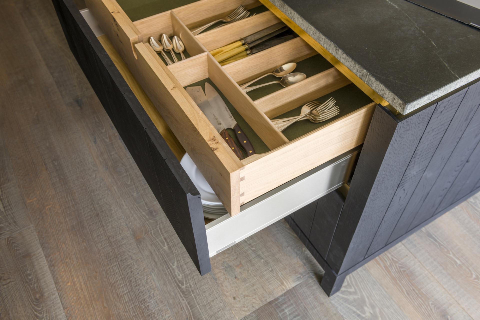 Cutlery drawer in a modern kitchen featuring organized utensils and a stylish Caesarstone countertop.