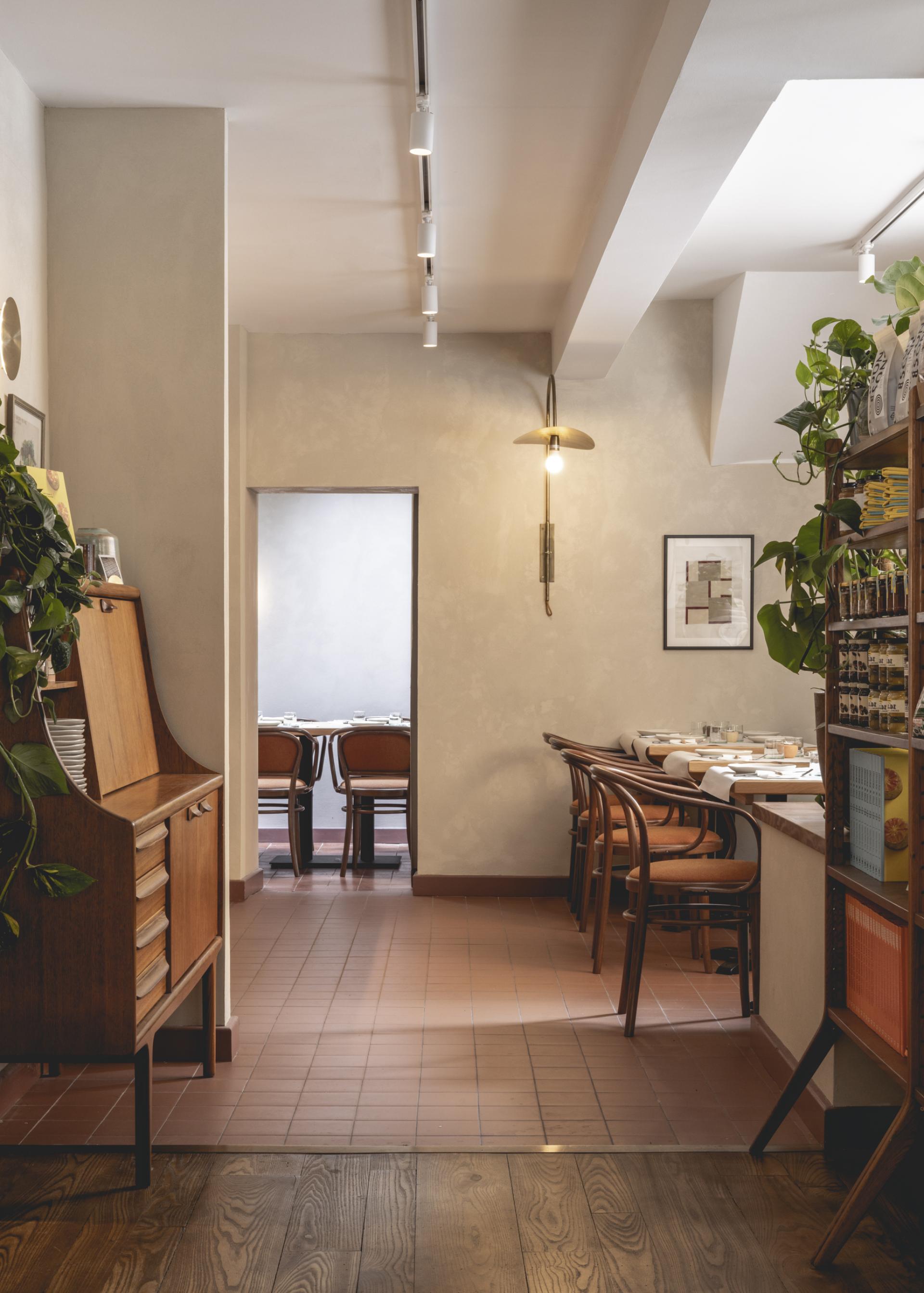 Modern interior of Honey & Co restaurant in Bloomsbury, featuring warm tones and stylish wooden furniture.