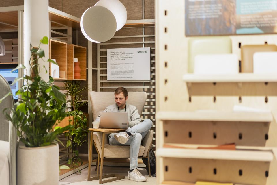 A man working on a laptop in a stylish, creative workspace at Material Source Studio Manchester.