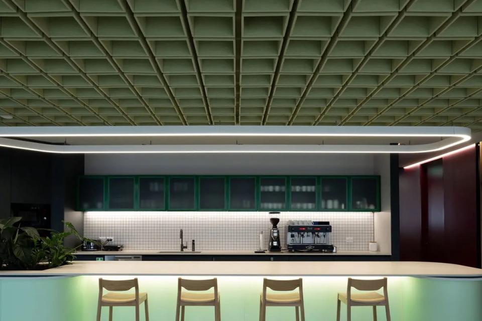 Sculptural acoustic ceiling tiles in a modern kitchen, enhancing aesthetics and sound absorption in interior design.