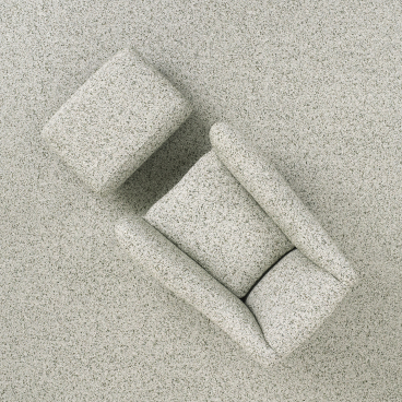 Balzac armchair by Matthew Hilton displayed on a textured gray surface, celebrating thirty years of design innovation.