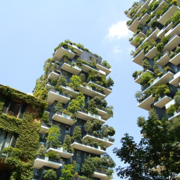 Contemporary green architecture featuring lush, vertical gardens on residential buildings, promoting urban sustainability and connection to nature.