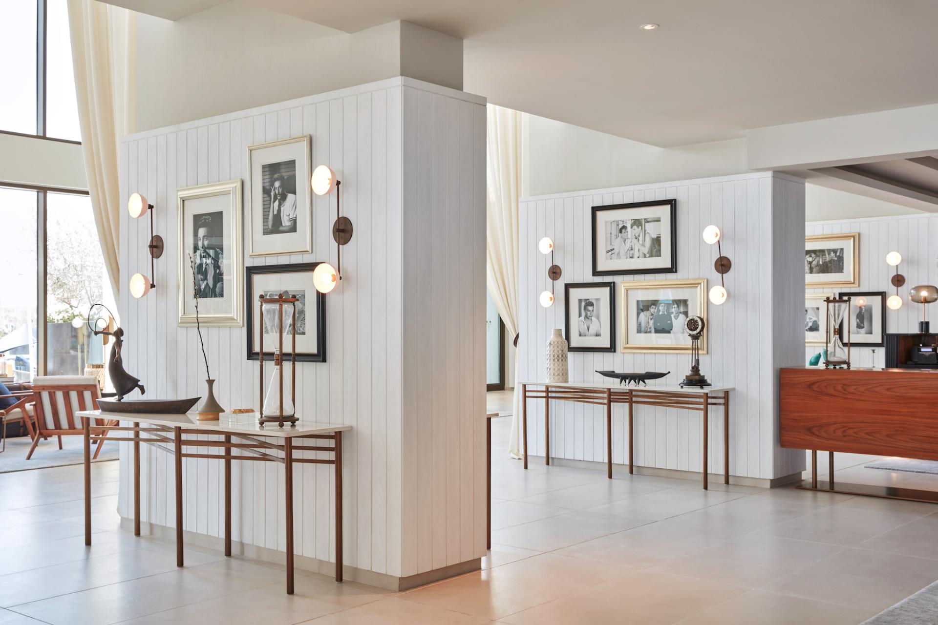 Stylish interior of a café featuring elegant furniture, framed photographs, and sophisticated lighting in a contemporary design.