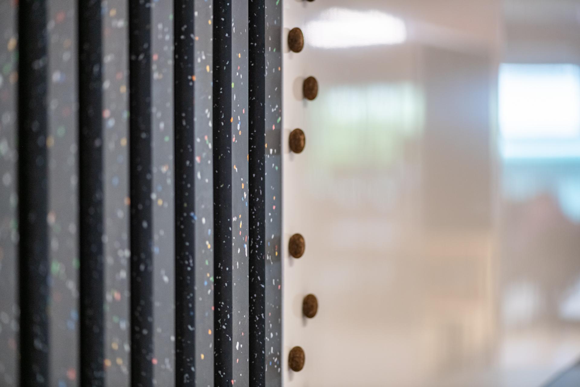 Colorful vertical panels and cork fixtures in a modern office design reflecting innovative workplace concepts for FinTech firms.