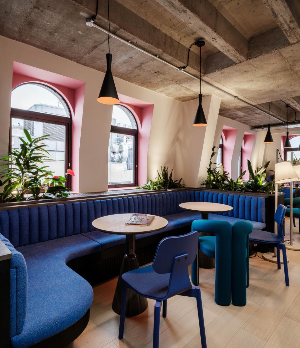 Vibrant co-working space at Huckletree Kensington featuring colorful seating, plants, and contemporary design elements.