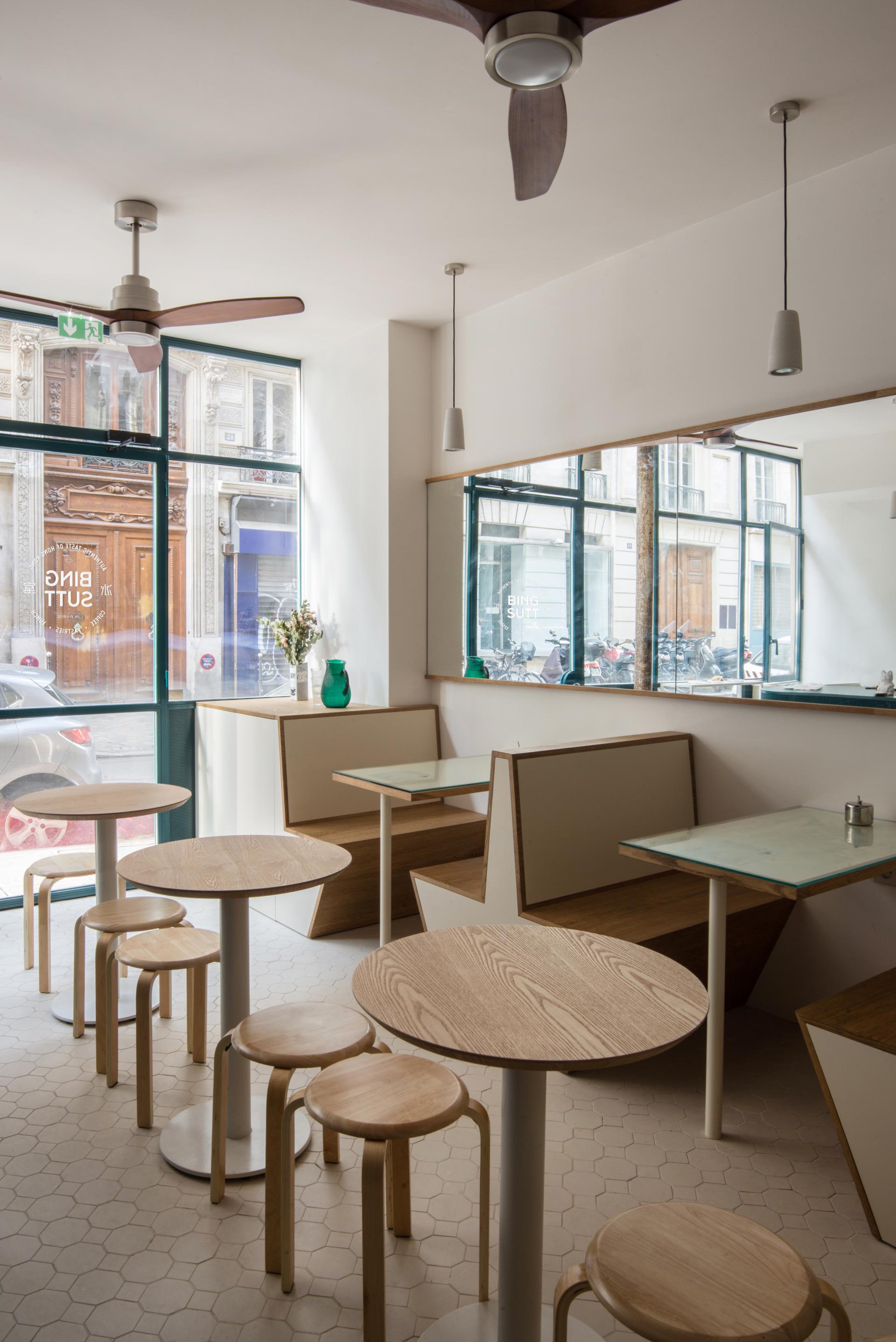 Modern Bing Sutt interior designed by HOP Architects, featuring minimalistic wooden furniture and large windows in Paris.