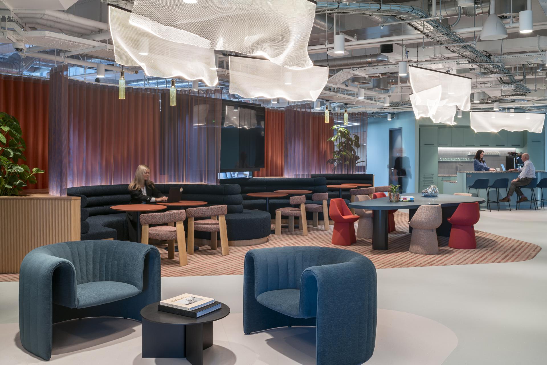 Modern workspace design at Virgin Media O2 headquarters features collaborative seating, vibrant decor, and welcoming atmosphere for employees.