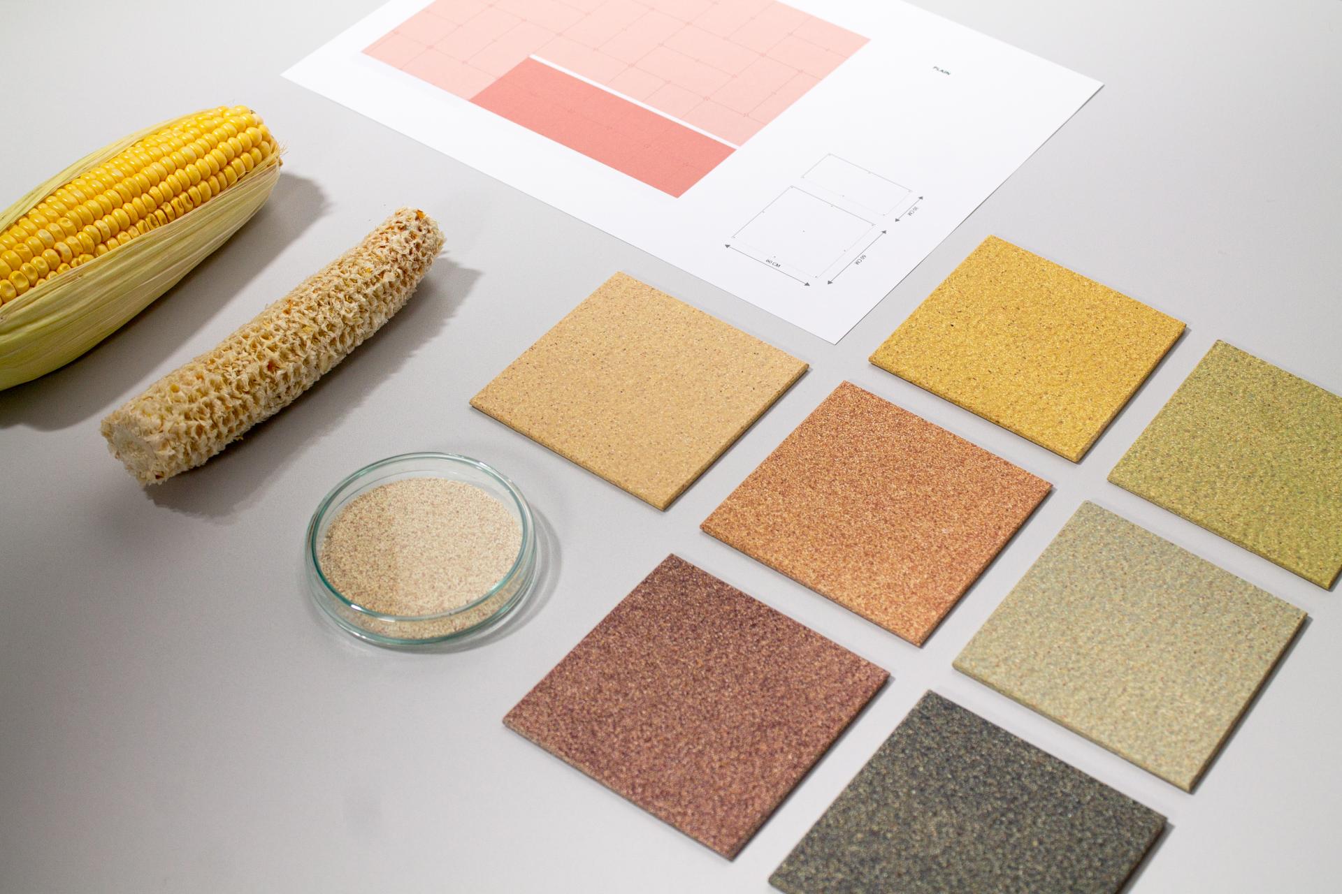 CornWall® material samples made from corncob cores, showcasing various colors and textures alongside organic corn and sand.