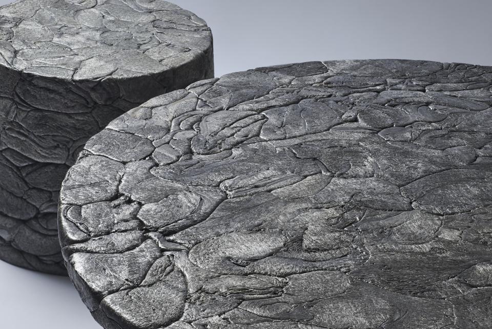 Stylish round tables designed from recycled styrofoam, showcasing a unique textured surface inspired by urban aesthetics.