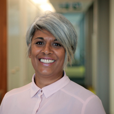 Chithra Marsh smiling in a professional setting, representing leadership and diversity in property and innovation.