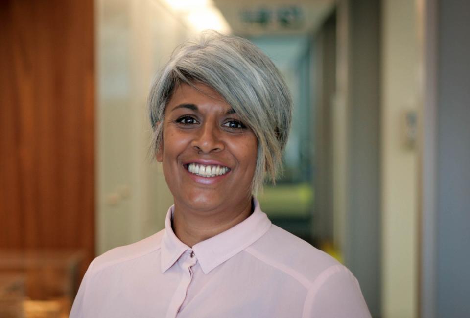 Chithra Marsh smiling in a professional setting, representing leadership and diversity in property and innovation.